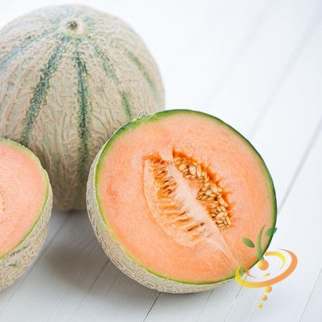 Hales Best Jumbo cantaloupe melon whole and halved with bright orange flesh and seeds on white surface