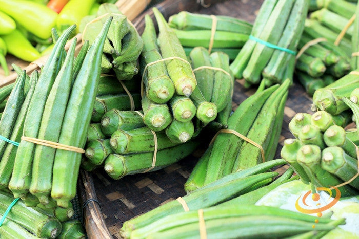 Bundles of fresh green Okra Dwarf Long Pod seeds displayed on a woven tray